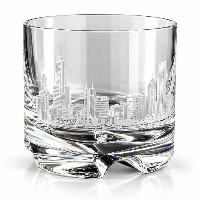 A clear glass rocks tumbler featuring an etched Chicago skyline design on the front, set against a clean white background.