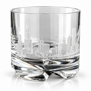 A clear glass rocks tumbler featuring an etched Chicago skyline design on the front, set against a clean white background.