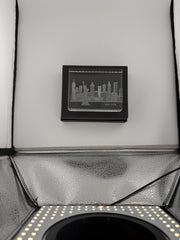 Sand-carved crystal paperweight featuring intricate city skyline engraving by Crystal House artisans.”