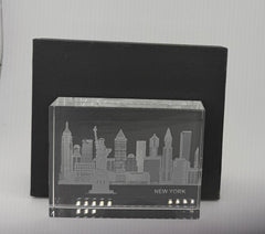 Sand-carved crystal paperweight featuring intricate city skyline engraving by Crystal House artisans.