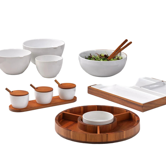 Set of wooden and ceramic kitchenware on a light surface with a geometric patterned wall in the background.