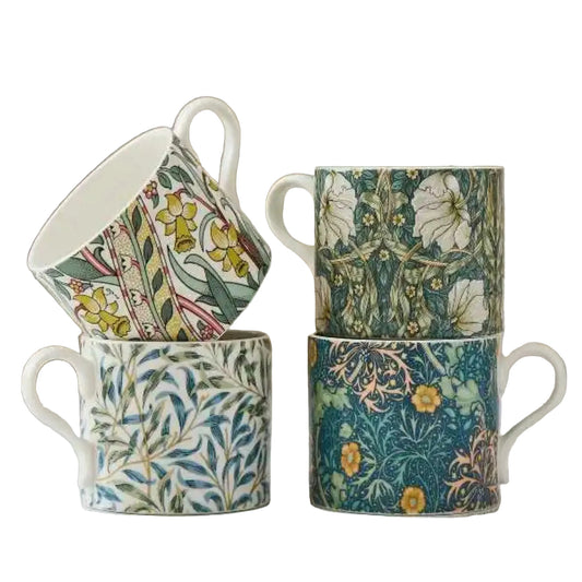 Set of four floral-patterned mugs on a light surface with a neutral background