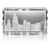 A rectangular clear crystal or glass keepsake box with an etched or printed Chicago skyline design on the front, shown on a white background with a soft reflection below.