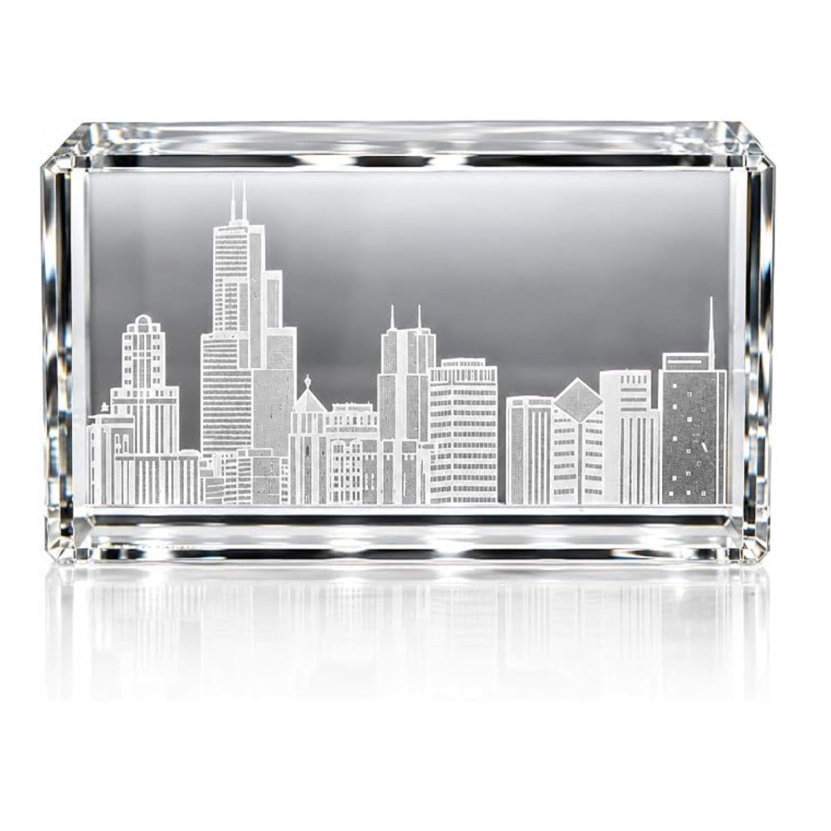 A rectangular clear crystal or glass keepsake box with an etched or printed Chicago skyline design on the front, shown on a white background with a soft reflection below.