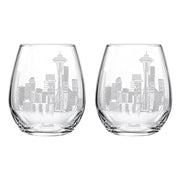 Two clear stemless wine glasses with an etched Seattle skyline design, including the Space Needle, on a plain white background.