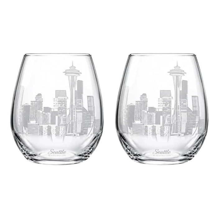 Two clear stemless wine glasses with an etched Seattle skyline design, including the Space Needle, on a plain white background.